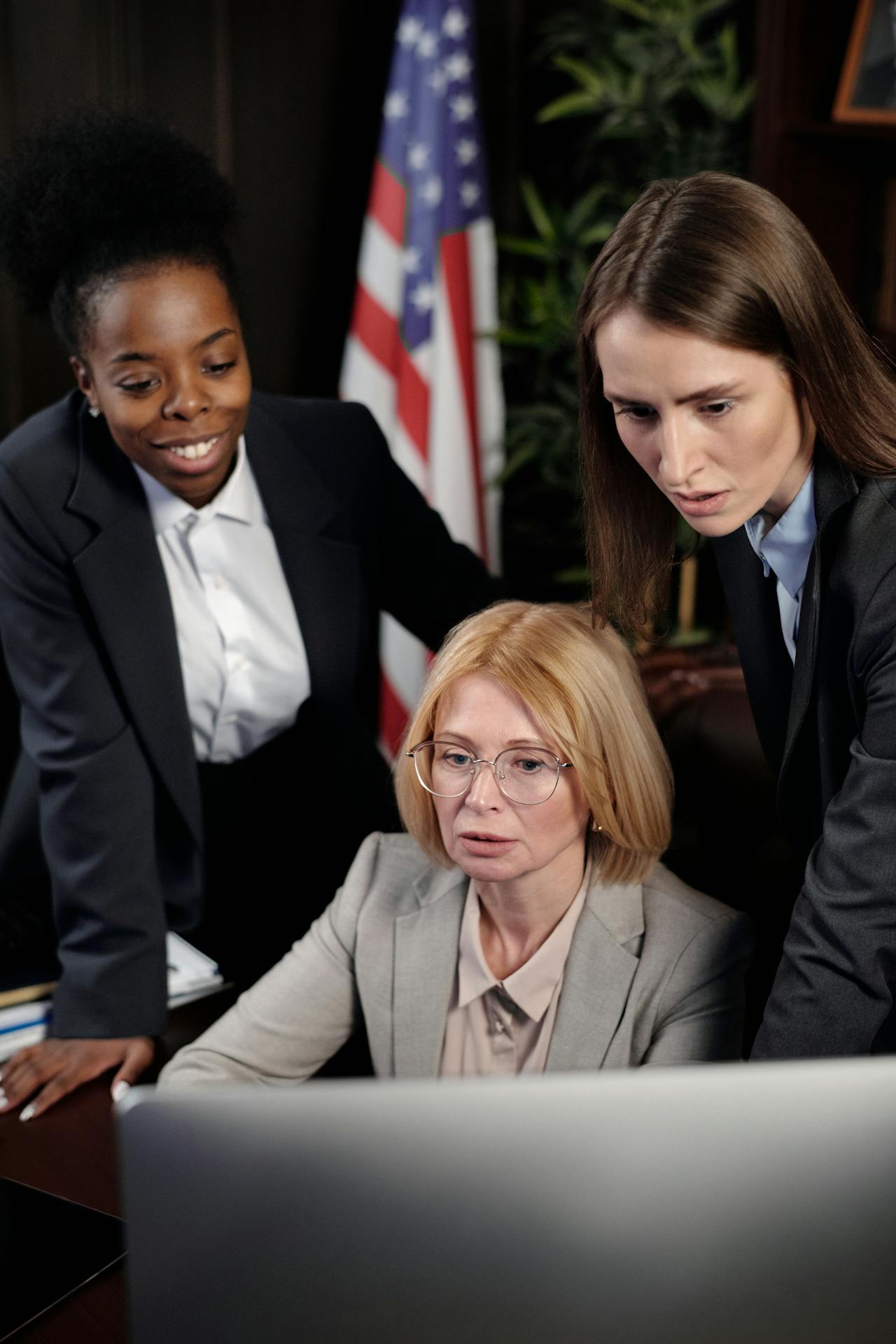 Lawyer consulting with client, lady justice statue on desk